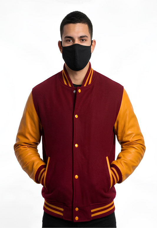 Person wearing a maroon and yellow varsity jacket with a black face mask on a white background