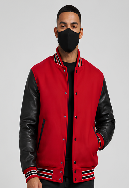 Person wearing a red varsity jacket with black leather sleeves on a gray background