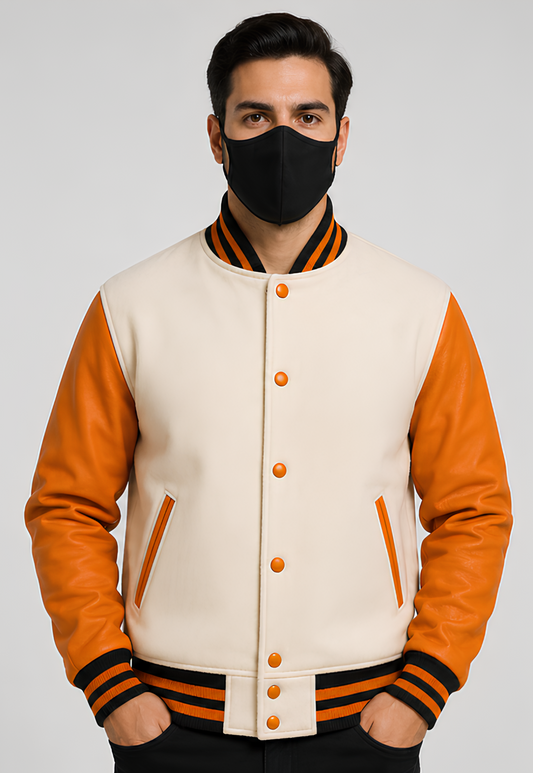 Person wearing a white varsity jacket  with orange sleeves and a black face mask on a white background
