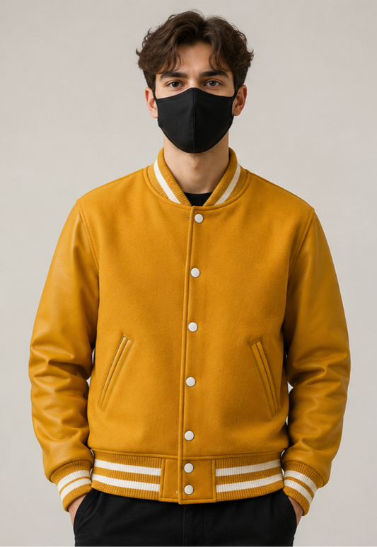 Person wearing a yellow varsity jacket with white accents on a plain background