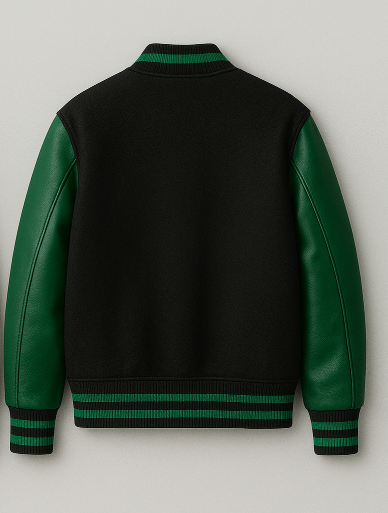 Black varsity jacket with green leather sleeves on a light gray background