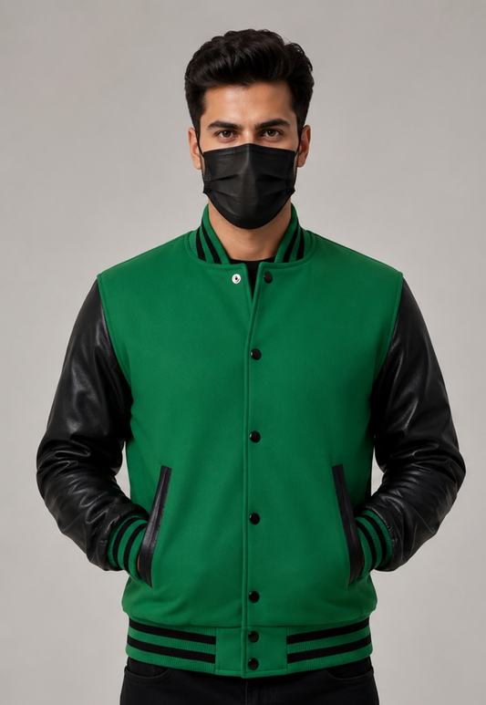 Man wearing a green varsity jacket with black leather sleeves on a gray background