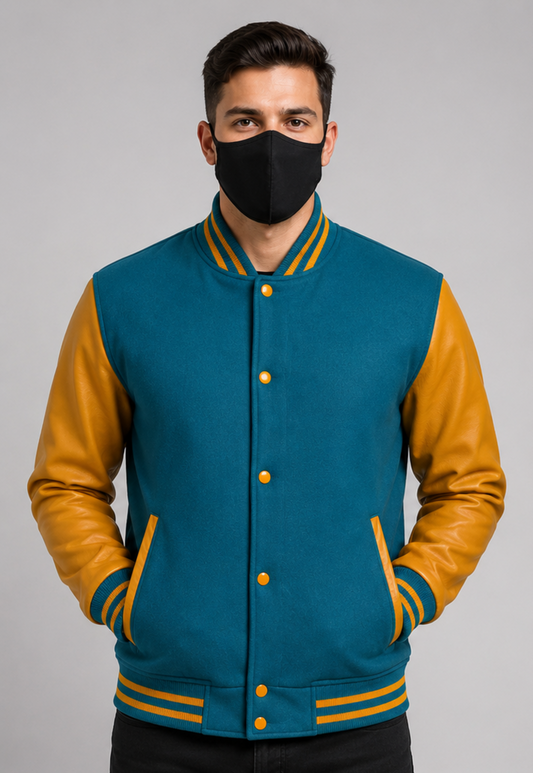 Man wearing a teal and golden varsity jacket with a black mask on a gray background