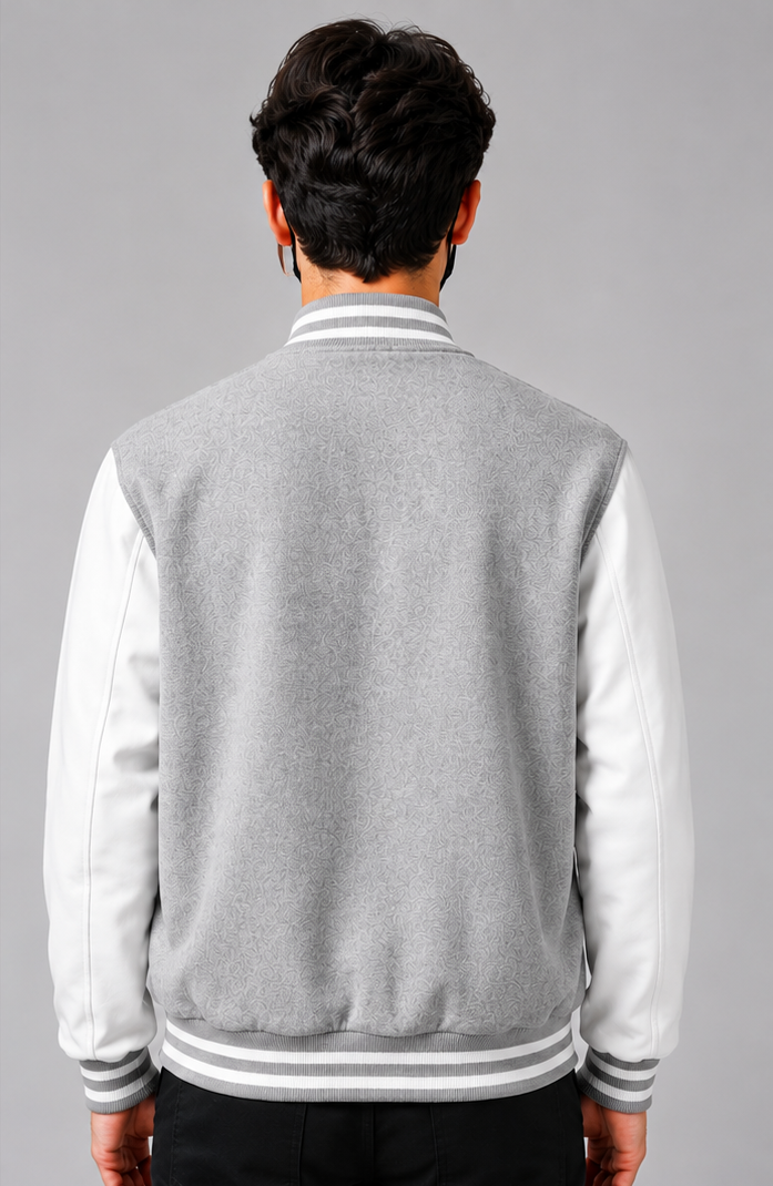 Gray and white varsity jacket worn by a person on a gray background