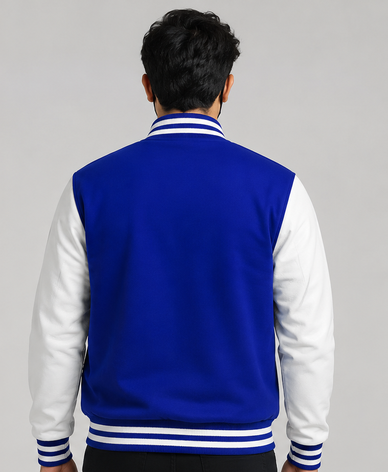 Person wearing a blue and white varsity jacket on a gray background