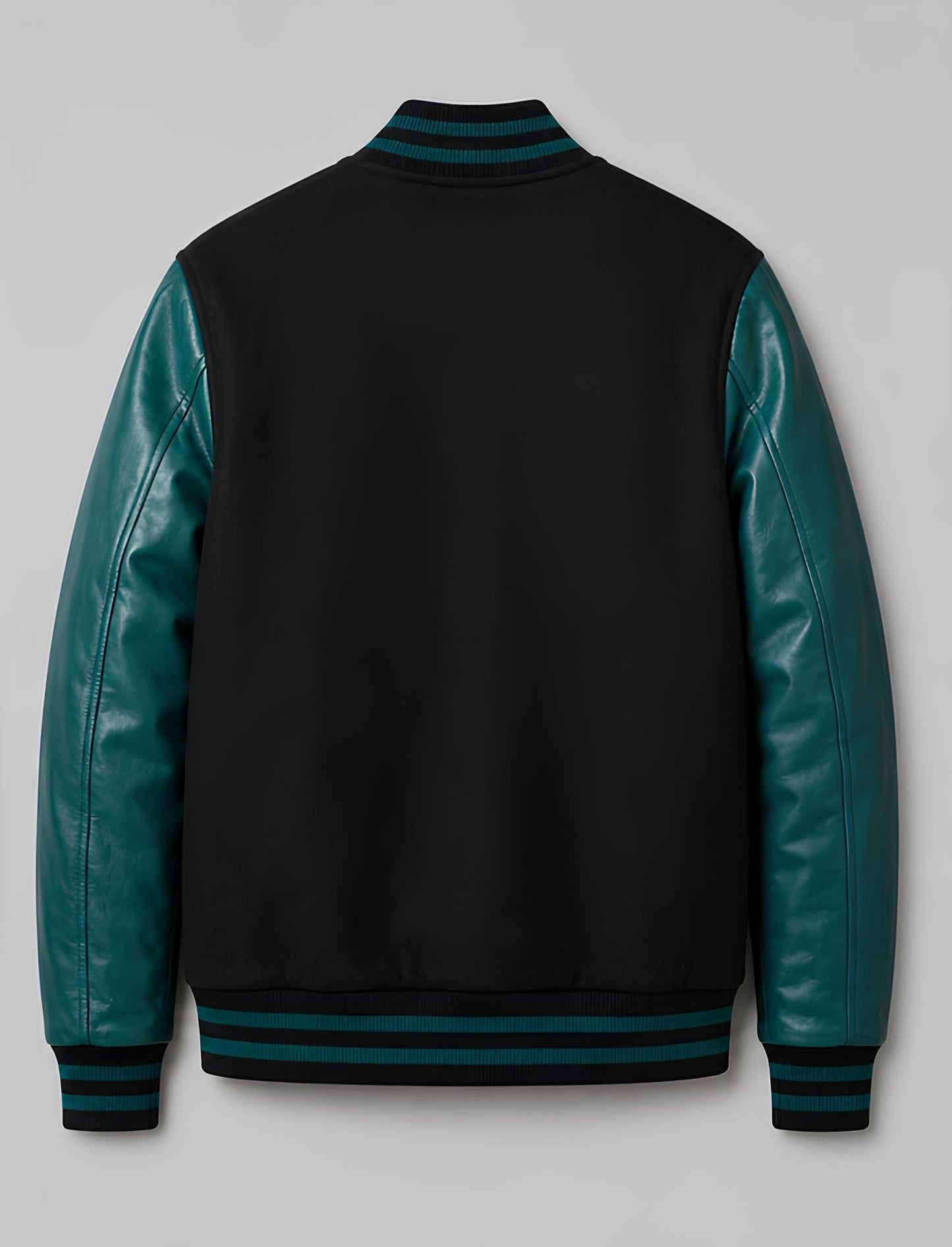 Black varsity jacket with teal leather sleeves on a gray background